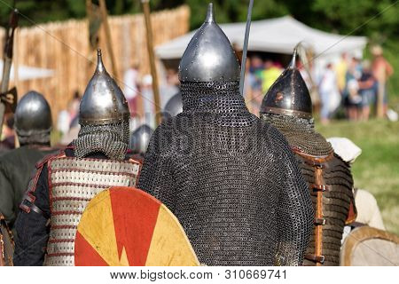 Medieval Warriors With Shields  In Armor From Back