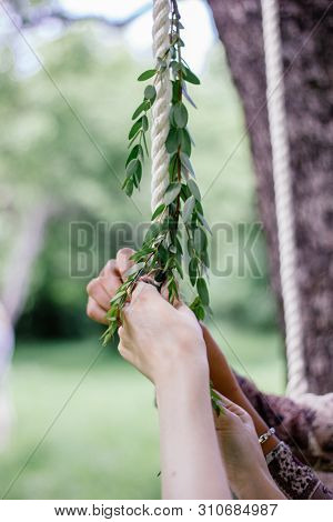 Florist Hands With The Green Branch At Park.