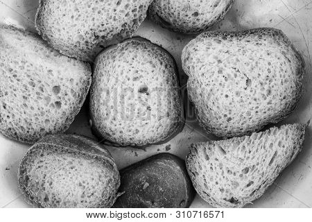 In The Frame Of Pieces Of Crackers. Black And White Photo, High Contast. The Bread Is Dried In The O