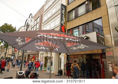 COLOGNE, GERMANY - CIRCA OCTOBER, 2018: Pizza Hut sign on umbrella at restaurant in Cologne.