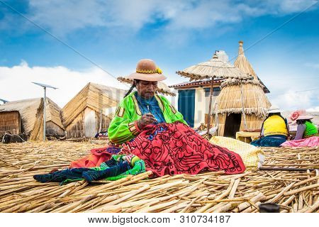 Uros, Peru- Jan 5, 2019: Inhabitants of Uros floating islands sell the rugs, Titicaca lake, Peru.