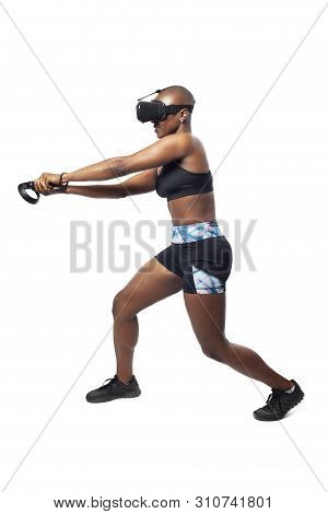 Athletic Woman Exercising While Playing Video Game By Practicing Vr Sword Fighting Or Swordplay With