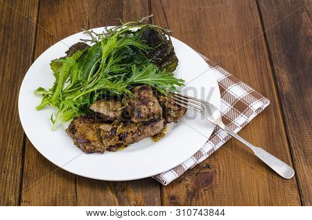 Slices Of Fried Liver, Green Leaves Of Salads