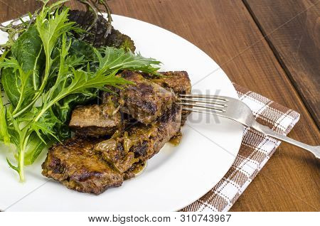 Slices Of Fried Liver, Green Leaves Of Salads