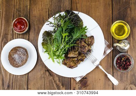 Slices Of Fried Liver, Green Leaves Of Salads