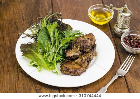 Slices Of Fried Liver, Green Leaves Of Salads