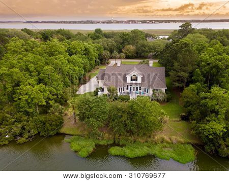 Aerial shot of watefront home with new roof at sunset.