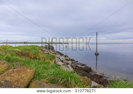 Stone Coast On The Atlantic Ocean With Island Grotta Near Reykjavik In The Morning With Clouds In Th