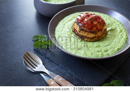 Traditional Australian Dish Called Pie Floater. Green Pea Soup Served With Australian Meat Pie. Aust