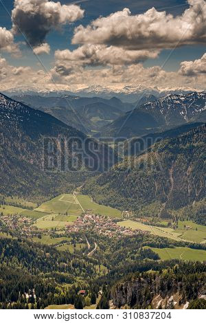 View From Top Of Mount Wendelstein In Upper Bavaria In The Late Spring, Featuring The Alps, Pastures