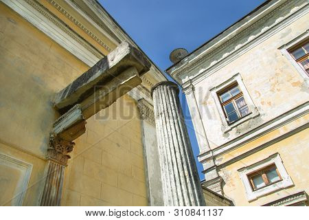 Windows And Columns Of The Old House Against The Bright Summer Sky
