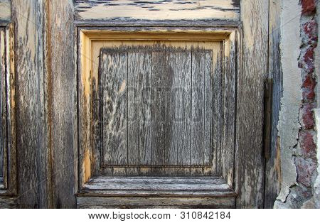 Element Of An Old Crumbled Wooden Door On One Hinge