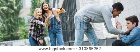 Panoramic Shot Of African American Boy In Hoodie And Jeans Bulling Boy And Teenager Shooting It And 
