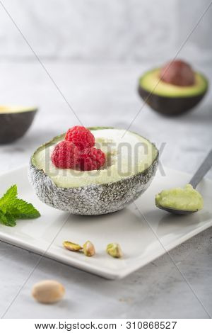 Homemade Organic Avocado And Pistacho Ice Cream With Raspberries