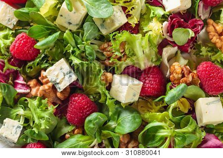Green Salad With Slices Of Blue Cheese , Raspberries And Walnuts.