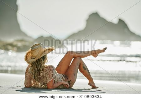 young woman relaxing on the beach in summer day