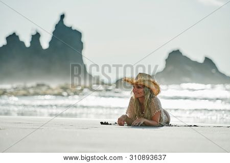 young woman relaxing on the beach in summer day