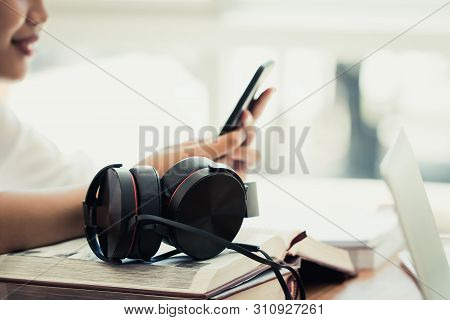 Attractive Asian Businesswoman / Student Young Woman Sitting Working On Smartphone With Headphone Fo