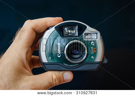 Paris, France - June 7, 2019: Man Hand Holding Vintage Waterproof Canon Ixus X-1 Elph Sport Ixy D5 F