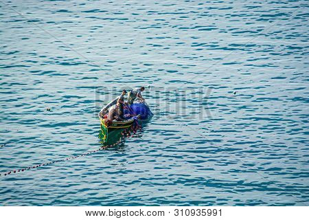 Cala Iris, Morocco - October 18, 2013. Fishermen On Boat Using Net Near Bay In Moroccan Coast Of Med