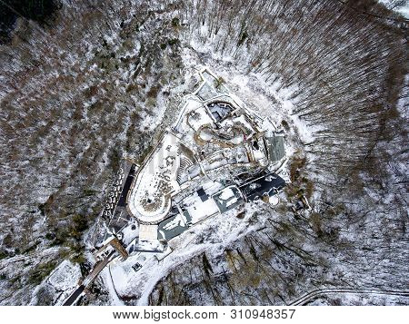 Aerial View Rock With Medieval Castle On It Near Moselle River In Brodenbach Winter With Forest Snow