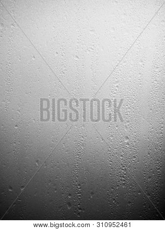 Vertical Image Of Water Drops, Condens On White Glass On A Cold Morning At Sunrise.