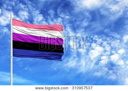 National Flag Genderfluid On A Flagpole In Front Of Blue Sky