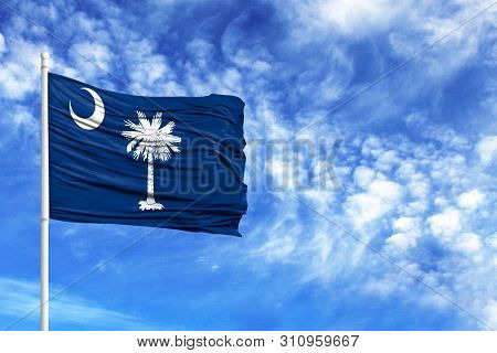National Flag State Of South Carolina On A Flagpole In Front Of Blue Sky