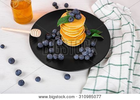 Image Shows A Homemade Fluffy Pancake With Blueberry And Mint On The Top; Situation Is Decorated Wit