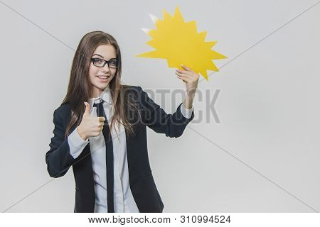 Young Business Woman Is Holding A Yellow Speech Bubble, Which Is Star-shaped, Isolated, On The White