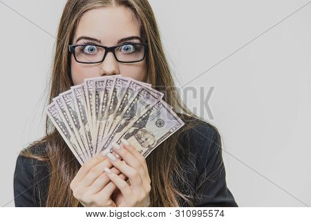 Happy Excited Young Business Woman Is Showing A Pile Of Money, Isolated On White Background. Girl Is
