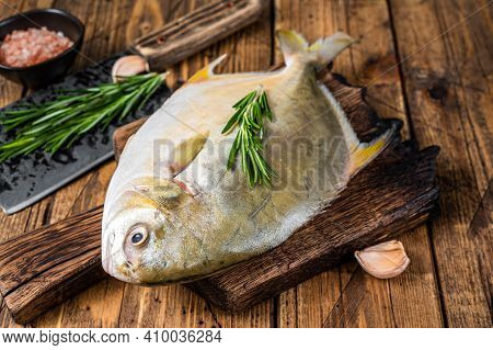 Raw Fish Sunfish Or Pompano On A Wooden Board. Wooden Background. Top View