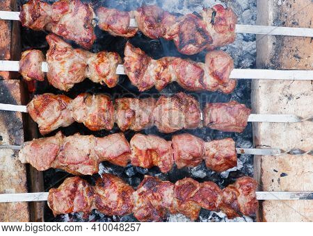 Delicious Grilled Pork Meat In Bbq Barbecue With Pork Meat. Kebabs On The Grill. Close-up Of Meat On