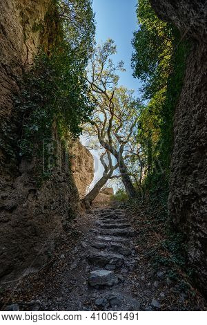 Ancient Passage Through A Narrow Mountain Gorge With A Raw Stone Staircase