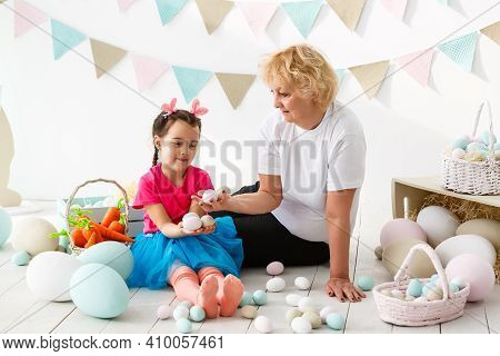 Easter Concept. Happy Llittle Girl And Grandmother With Easter Eggs