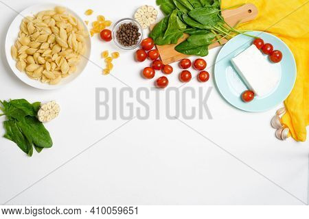 Ingredients For Oven-baked Feta Cheese With Tomatoes And Pasta, Pepper Garlic On A Light Background