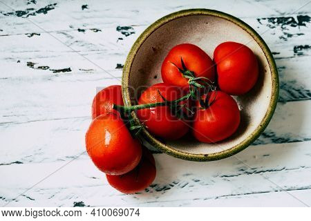 Fresh Oraganic Tomatoes On A Branch