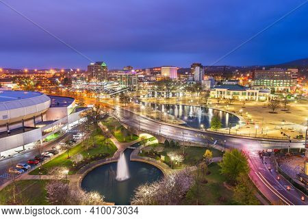 Huntsville, Alabama, USA park and downtown cityscape at twilight.