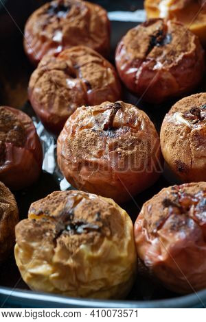 Backed Apples Decorated With Cinnamon Powder In A Cermic Tray Cozy Home Made Food Concept. Close Up.