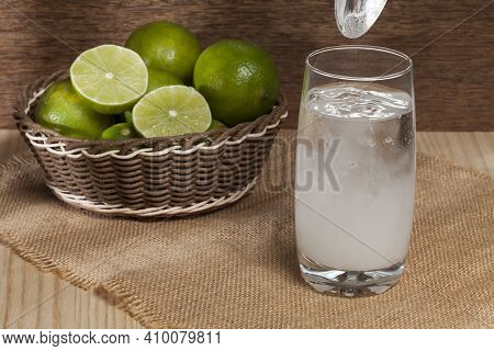 Water, Baking Soda And Lemon; Photo On Wooden Background.
