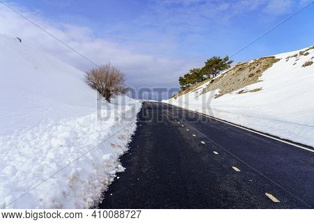 High Mountain Road With Clouds And Blue Sky. Morcuera Madrid.