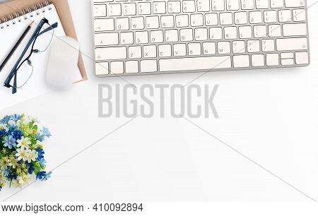 White Minimal Office Desk Table With Notebook,glasses And Flower And Mini Mouse And Keyboard Wireles