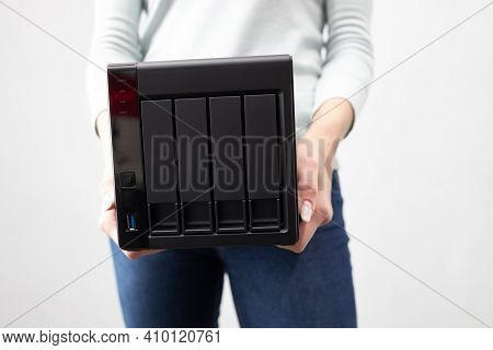 Girl Person Hold In Hands Portable Office Or Home Data Nas Server. Device For Backup Important Infor