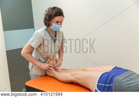 Physiotherapist And Patient In Global Postural Re-education Session, With Pandemic Protection Mask.