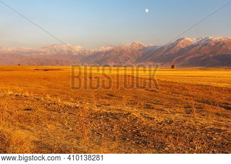 Mountains In Kazakhstan, Talas Alatau. Mountains And Agricultural Field At Sunset In The Evening.