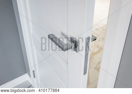 Modern Metal Door Handle On White Wooden Door In Interior. Knob Close-up Elements. Door Handle, Fitt