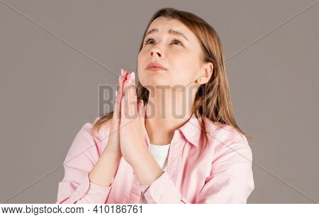 Gloomy Dissatisfied Woman Keeps Palms In Prayer Gesture, Feels Sorry For Making Mistake, Asks For Fo