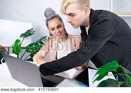 Office Work, Business. Young Attractive Man Helping His Female Colleague To Deal With The Project. H