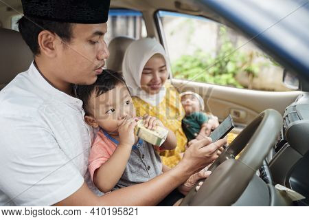 Muslim Family Travel By Car And Talk Using Video Call On Their Phone
