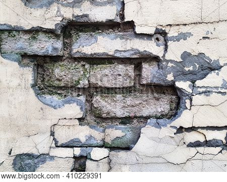 Background Of A Crumbling Brick Wall Close-up. The Texture Of A Crumbling Wall